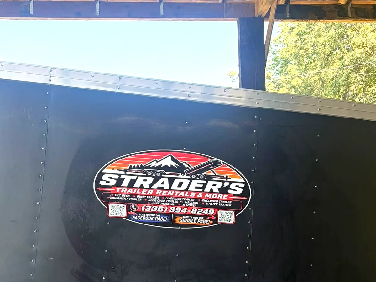 Strader's Trailer Rentals & More decal on the side of an enclosed trailer